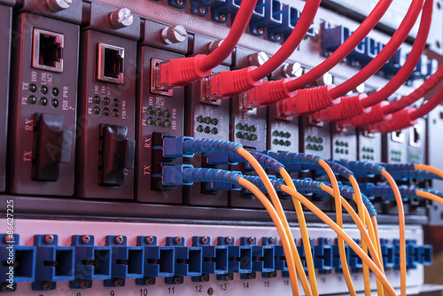 Fiber Optic cables and UTP Network cables connected hub ports.