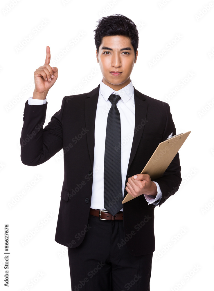 Young businessman holding with clipboard and finger point up Young businessman holding with clipboard and finger point up