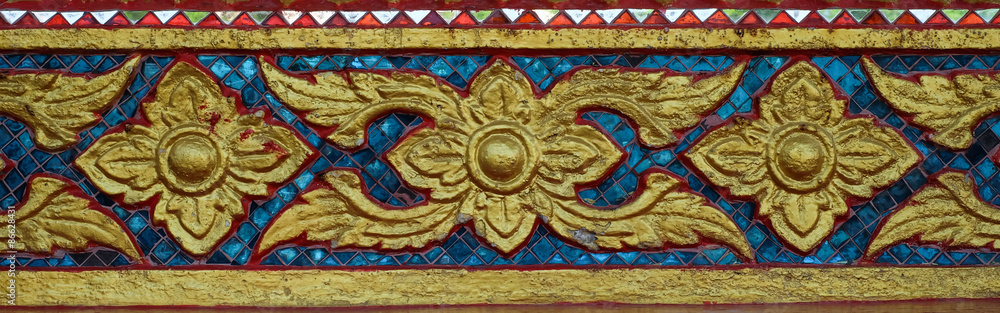 Ancient golden carving window of Thai temple. Thailand