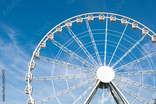 white ferris wheel against blue sky background