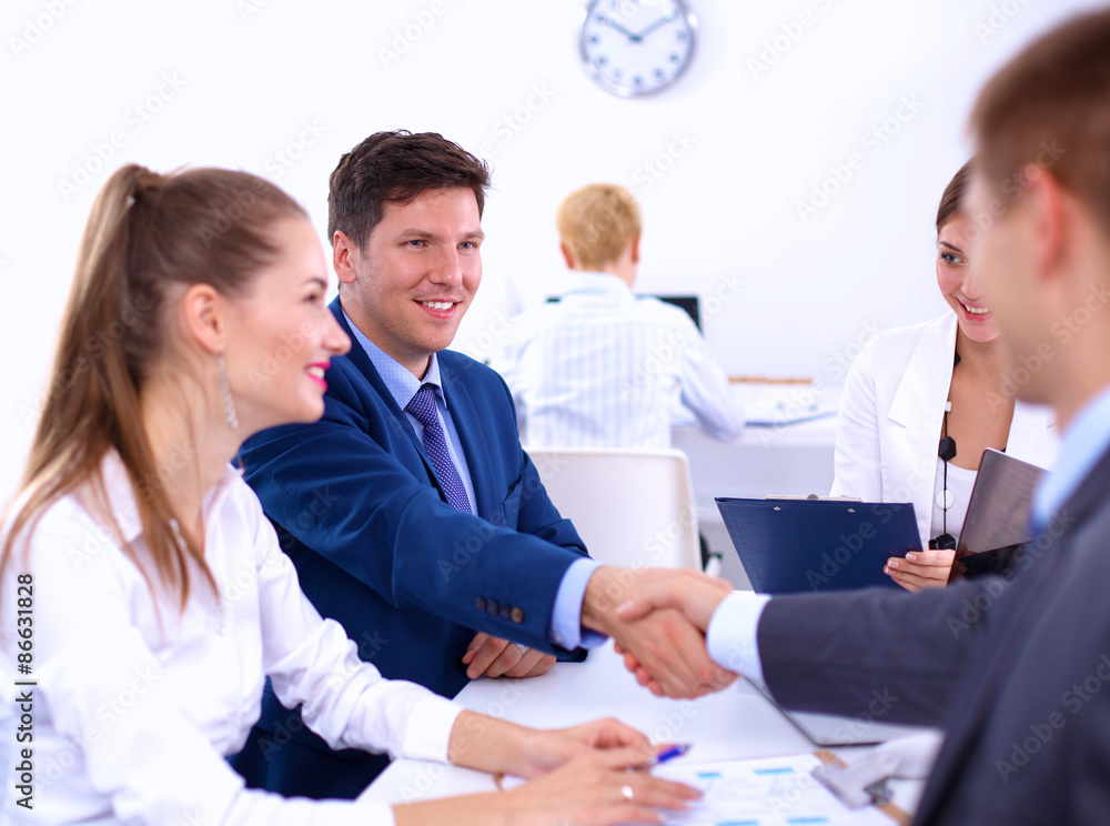Fototapeta premium Business people shaking hands, finishing up a meeting, in office