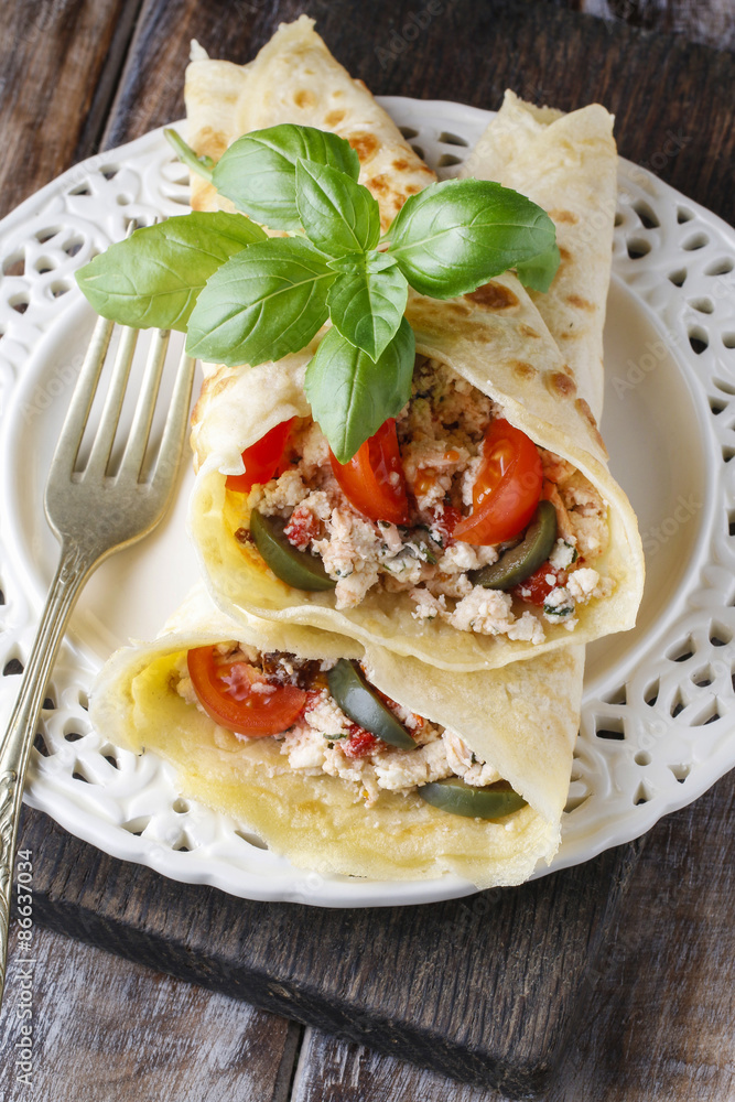 Mediterranean cuisine: crepes stuffed with cheese and vegetables Mediterranean cuisine: crepes stuffed with cheese and vegetables