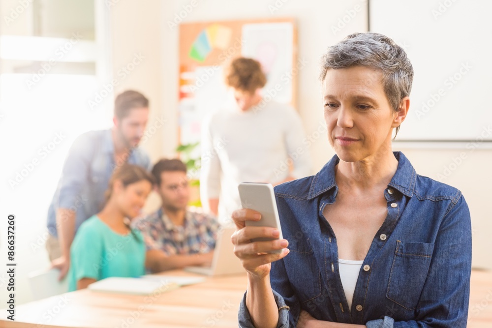Fototapeta premium Casual businesswoman using her smartphone 