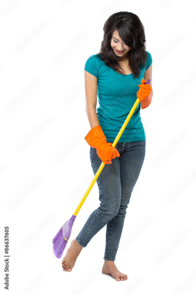 Beautiful asian woman with gloves, sweeping the floor with a bro Beautiful asian woman with gloves, sweeping the floor with a bro