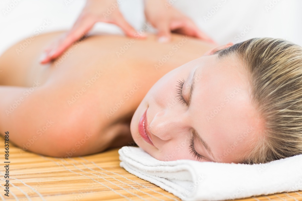 Pretty blonde enjoying a massage smiling at camera Pretty blonde enjoying a massage smiling at camera