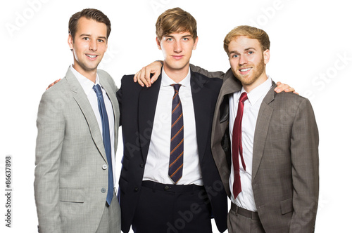three businessmen smiling and embrace each other