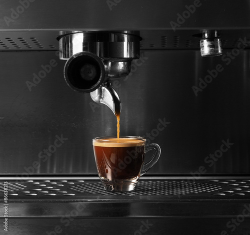 Hot coffee flow to a cup on espresso machine