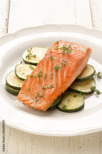 grilled salmon fillet with zucchini on a plate