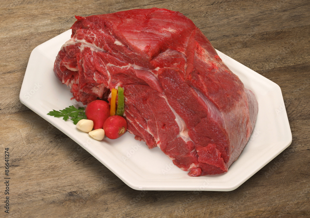 Raw meat selection on wooden cutting board with knife Raw meat selection on wooden cutting board with knife