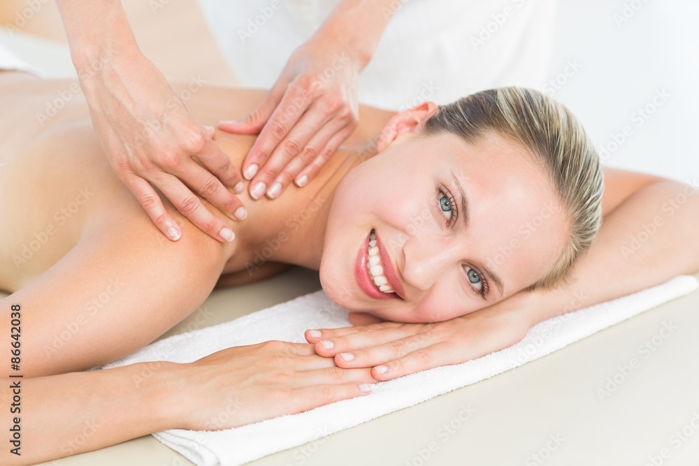 Pretty blonde enjoying a massage smiling at camera Pretty blonde enjoying a massage smiling at camera