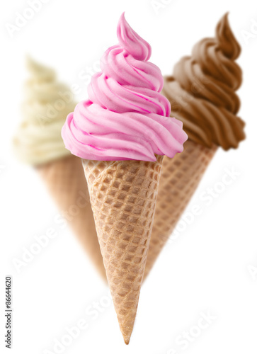 Ice cream cone with vanilla, strawberry and chocolate flavor wafer isolated