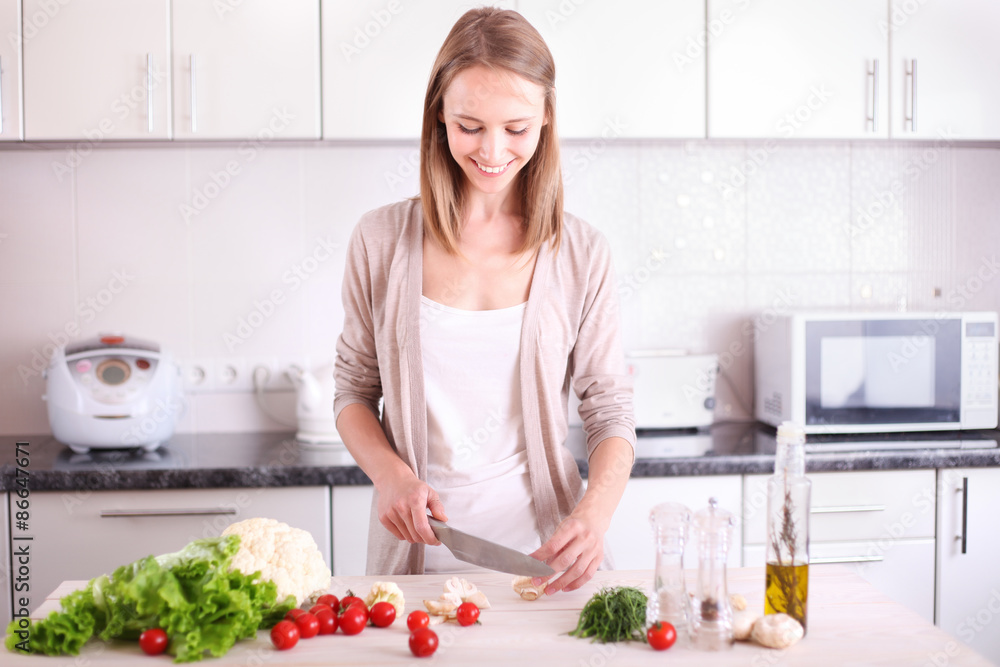 Young Woman Cooking in the kitchen.