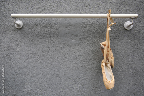Old Used Ballet Shoes Hanging on metal rod
