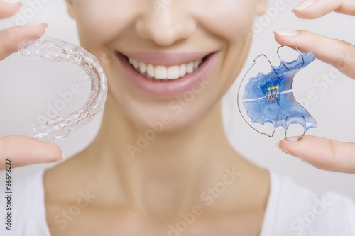 Smiling girl Holding Retainer for Teeth and Tooth Tray