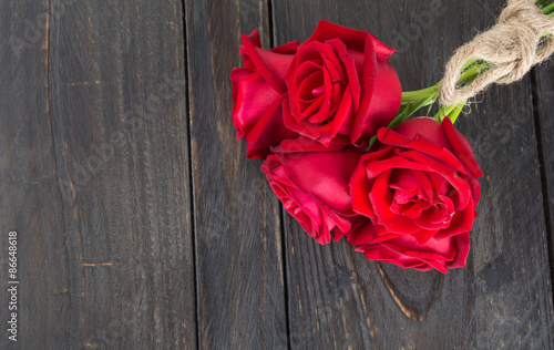 red rose bouquet on wood background