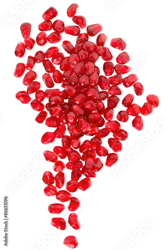 Cut the pomegranate with scattered grain top view isolated