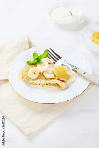 Delicious crepes with banana and honeycomb