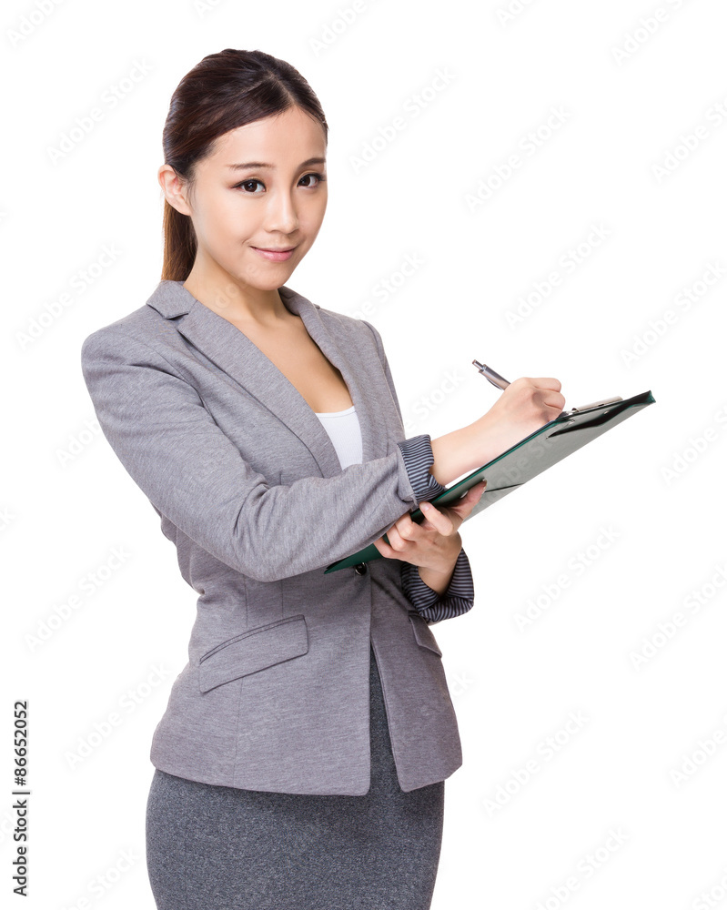 Young businesswoman write on clipboard Young businesswoman write on clipboard