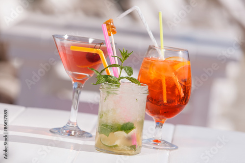 Three refreshing  summer cocktails at a beach bar