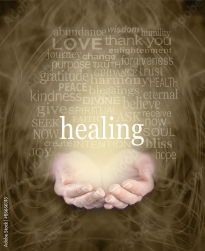 Fototapeta Naklejka Na Ścianę i Meble -  Gentle Healing Words - Female cupped hands with the word 'healing' floating above surrounded by a healing word cloud on a swirling misty sepia colored energy background