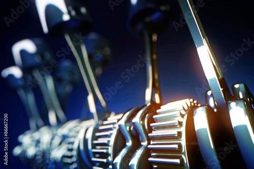 3d rendered illustration of engine pistons and cog wheels with depth of field effect