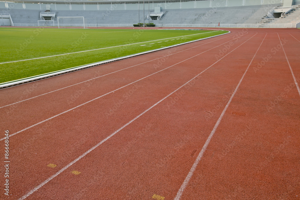 Fototapeta premium Running track with lawn yard for the athletes background