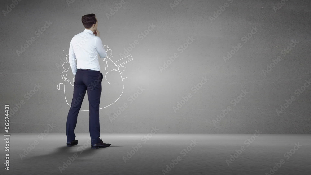Businessman looking at grey wall with brainstorm Businessman looking at grey wall with brainstorm