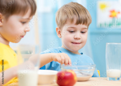 children eat healthy food at home or kindergarten
