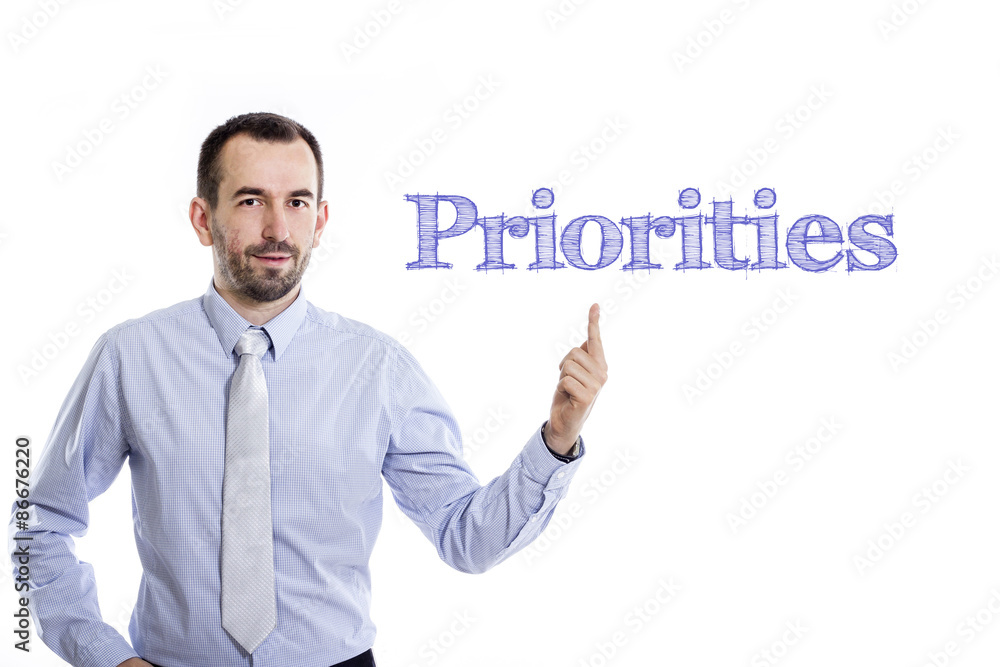 Priorities Young buinessman pointing up Priorities Young buinessman pointing up