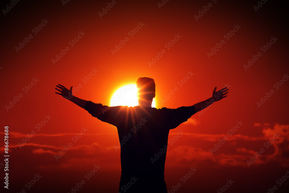 Man facing the sun finding power source