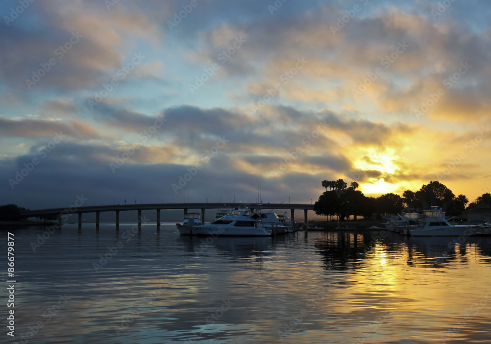 A Gorgeous Sunrise Over a Bridge and Marina