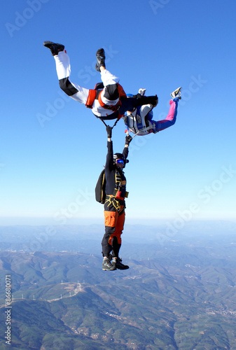 Skydiving photo. Maneuvers in free fall. Formation friends.