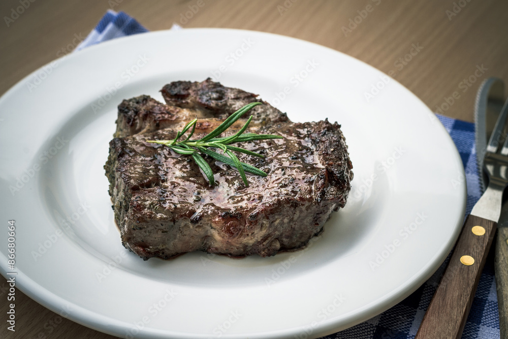 Juicy grilled rib eye steak with cutlery Juicy grilled rib eye steak with cutlery