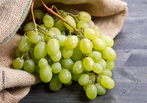bunch green grapes on wooden background