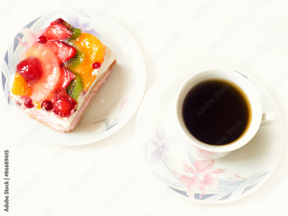 Yogurt dessert with fruits and berries in jelly and a cup of coffee on a white background Yogurt dessert with fruits and berries in jelly and a cup of coffee on a white background