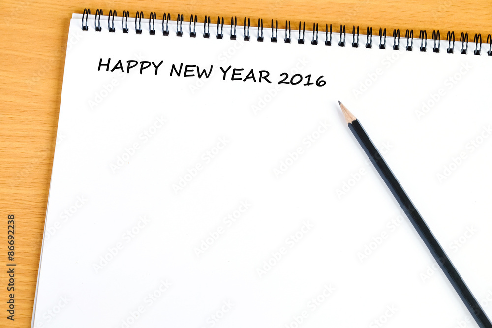 Happy new year 2016 words on blank note book background Happy new year 2016 words on blank note book background