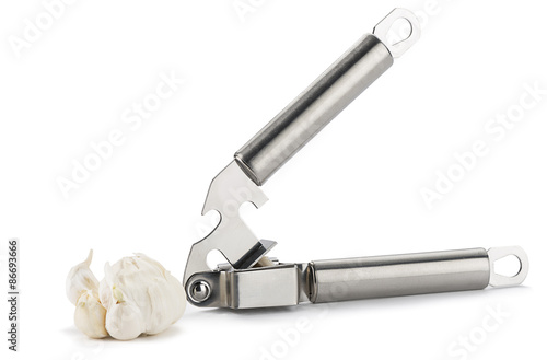 Close-up of a garlic clove and press isolated on white 