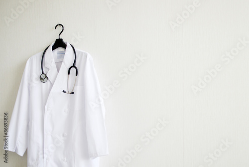 壁にかけられた白衣と聴診器 photo