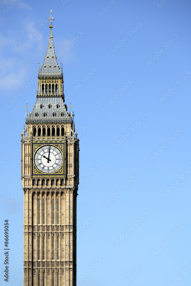 Big Ben London clock tower houses of parliament isolated against a deep blue sky photo