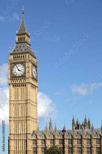 Big Ben London clock tower houses of parliament building deep blue summer sky photo vertical