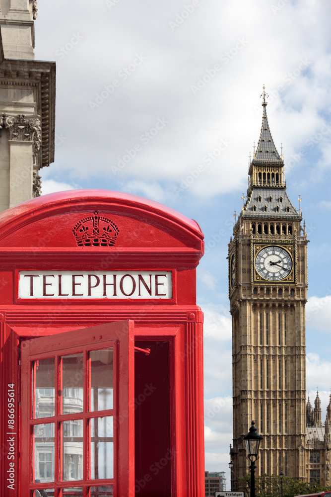 Obraz premium London red telephone box booth with Big Ben clock tower in the background photo vertical