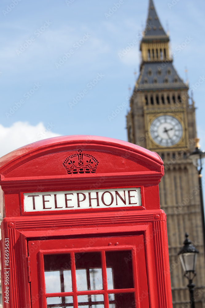 Fototapeta premium London red telephone box booth with Big Ben clock tower in the background photo vertical