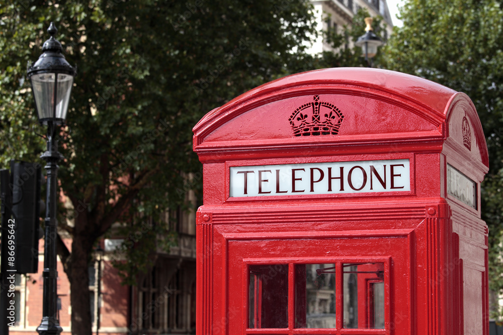 London red telephone box booth with Hyde Park in the background photo London red telephone box booth with Hyde Park in the background photo