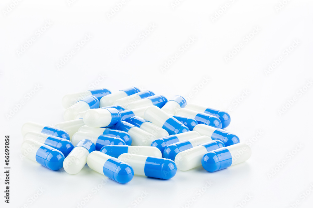 blue and white Pills (Capsules) with Many in Background Isolated blue and white Pills (Capsules) with Many in Background Isolated