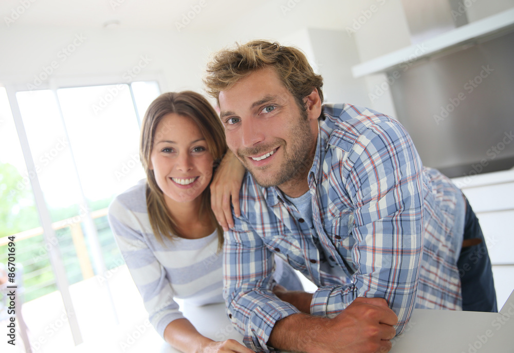 Portrait of couple standing in modern kitchen Portrait of couple standing in modern kitchen