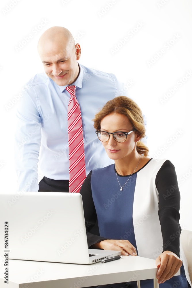 Teamwork. Senior businessman and businesswoman using a laptopt together Teamwork. Senior businessman and businesswoman using a laptopt together