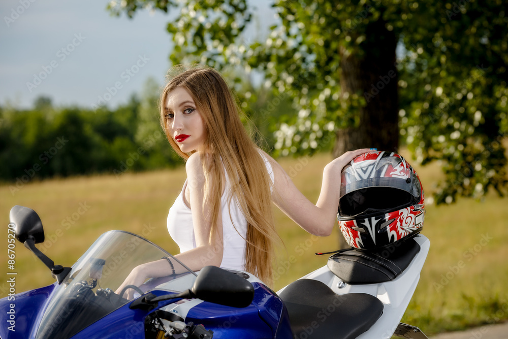 beautiful young woman with a motorcycle speed in nature beautiful young woman with a motorcycle speed in nature