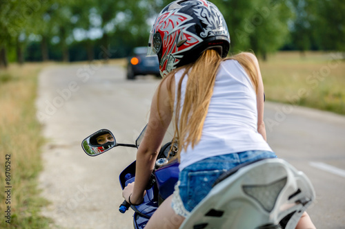 beautiful young woman with a motorcycle speed in nature © czamfir