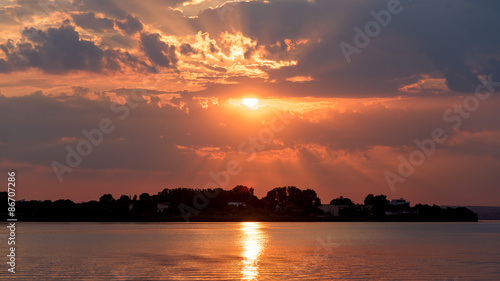 Summer Sunrise With Beautiful Cloudy Sky Over Calm Lake Water
