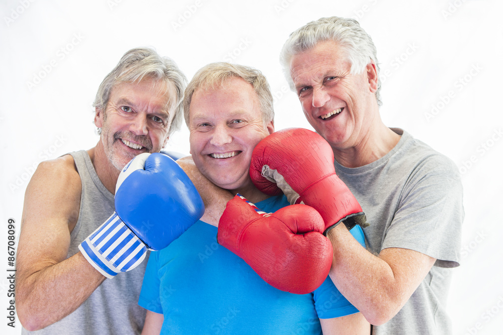 Three men posing in boxing gloves